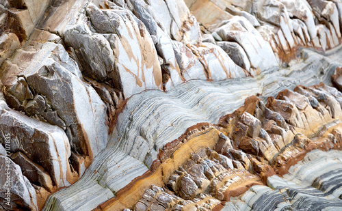 Close-up of stratified rock layers with varied colors and intricate patterns