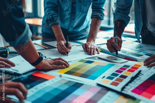 Creative digital agency.UX developer and UI designer brainstorming about mobile app interface wireframe design on table with customer brief and color code.