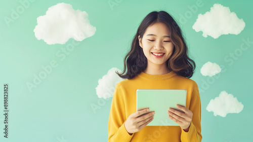 Promote our cloud-based office collaboration tools, with a happy Asian girl working on a tablet on a light green background.