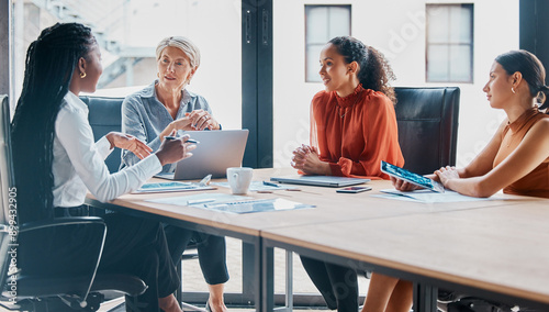 Office, boardroom and business women in meeting for teamwork, collaboration and planning. Corporate workers, diversity and people with laptop for project review, feedback and discussion with manager