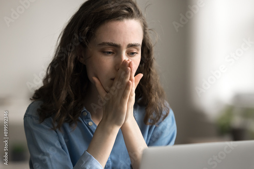 Close up sad young student woman look at laptop screen, check email, read bad news, receive message with negative test result, failed exam, feel unhappy, college expulsion, feels shocked about failure