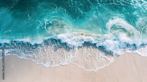 Overhead photo of crashing waves on the shoreline beach. Tropical beach surf. Abstract aerial ocean view