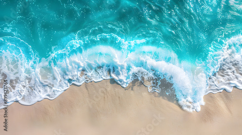 Overhead photo of crashing waves on the shoreline beach. Tropical beach surf. Abstract aerial ocean view