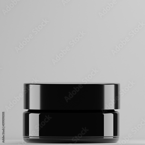 black cylindrical jar with a glossy finish. It has a matching black lid and appears to be empty. The jar is standing on a plain white background, ideal for showcasing skincare or cosmetic products.