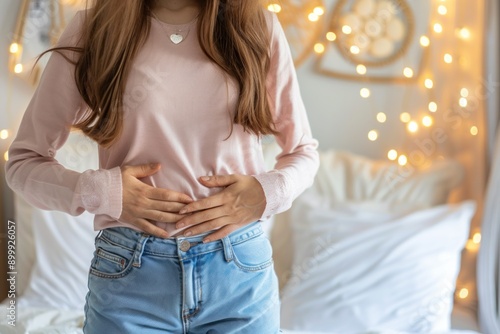 Woman touching her belly suffering from pain at home. Stomach pain, swollen abdomen, menstrual pain, ovaries and nausea