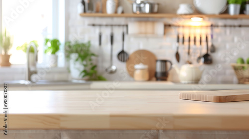 Modern kitchen with light-colored countertop, blurred background showcasing cooking utensils, and decor items for a stylish look.