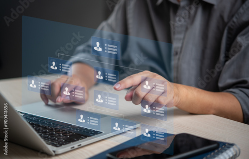 Person managing digital organizational chart on a laptop, indicating structured business management and HR processes. Suitable for corporate, HR, and management content.