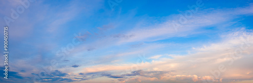 A beautiful blue sky with pink clouds. The sky is a perfect backdrop for a beautiful day