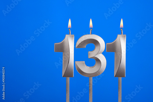 Birthday number 131 - Candle lit on blue background