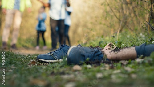 Search party team finding unrecognizable barefoot dead body in the woods, rescuers calling the police to deal with the mysterious gruesome homicide. Hopeless corpse murdered in the forest. Camera A.