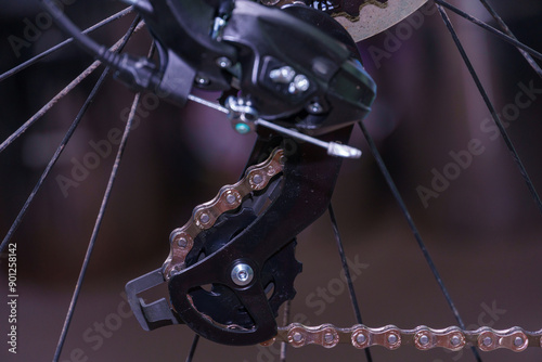 Mountain bike repair and maintenance. The rear derailleur is a close-up on a black background.