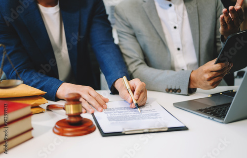 Business and lawyers discussing contract papers with brass scale on desk in office. Law, legal services, advice