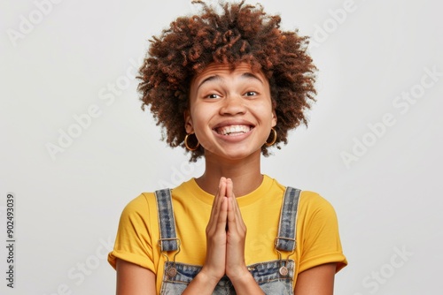 Praying gesture palms, satisfied woman begs for mercy, positive expression, gentle smile, makes wish