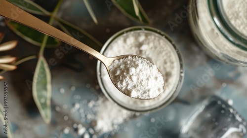 A spoonful of powdered magnesium hovers above a glass jar, surrounded by soft greenery, capturing a moment of natural wellness