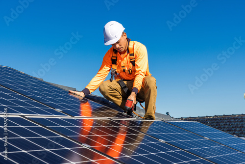 Solar panel technician with drill installing solar panels