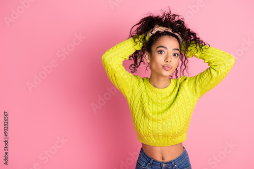 Portrait photo of youth model teenager girl pouted her lips making kisses touching curly hairstyle isolated on pink color background