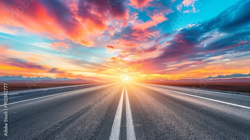 Empty highway stretching into sunrise, vibrant sky, panoramic view, dramatic lighting