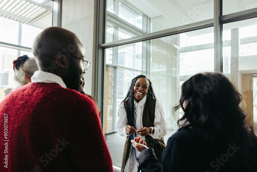 Successful black woman engaging with colleagues in a corporate meeting