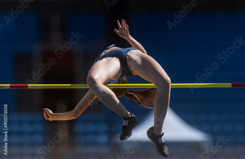 Young woman in high jump.Track and field theme. Horizontal sport theme poster, greeting cards, headers, website and app