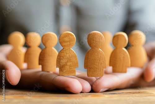 Protecting Our People: A pair of hands cradles a circle of wooden figurines, symbolizing the importance of caring for and protecting employees in the workplace. The warm, natural tones of the wood an