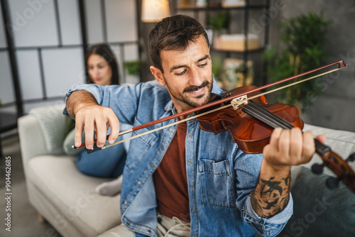 Adult man learn how to play violin practice at home