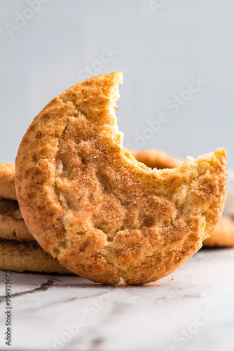 A snickerdoodle cookie with a bite taken out