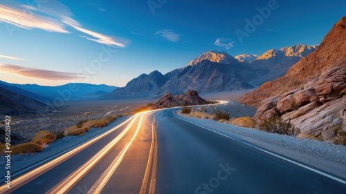 Long exposure of a deserted desert road at night with a car's headlights illuminating the path.