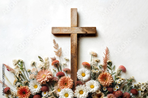 Wooden cross with flowers on white background with copy space