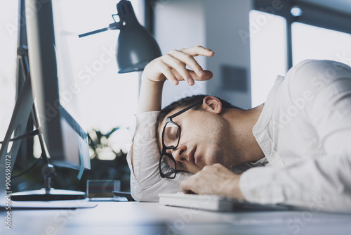 Lazy office worker sleeping at his desk