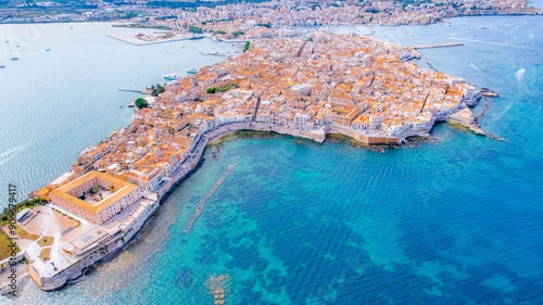 Aerial of Ortigia island, old town with turquoise sea of Syracuse. Small island on Sicily, Italy.