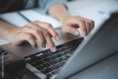 Close up, woman hand typing on laptop computer keyboard. Business woman online working on laptop computer, surfing the internet, searching the information at home office, e-learning