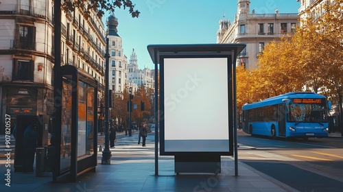 Blank advertising billboard mockup at a bus stop in madrid city,with a blue bus and historical building in the background