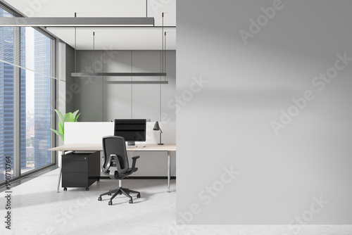 Grey workplace interior with pc monitors on tables in row, window. Mockup wall