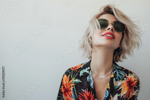 A confident, tattooed influencer in her 20s with a fashionable hairstyle and outfit, smiling against a clean white background