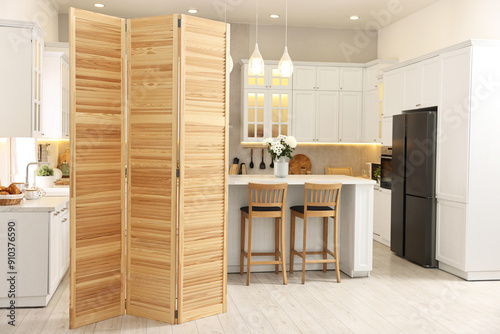 Stylish kitchen interior with folding screen and table