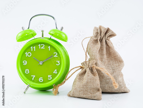 A green clock and burlap sack isolated with white background.