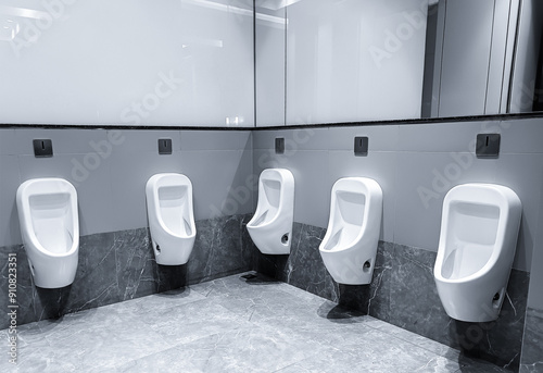 Men's room with white porcelain urinals