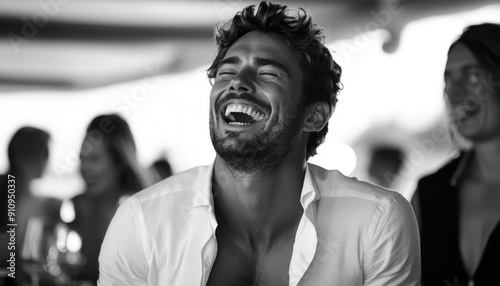 In a striking black and white photograph, a man can be seen laughing joyfully and candidly