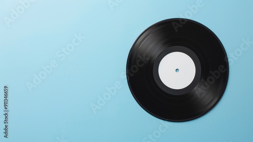 A vinyl record with a clear center label, positioned on a dark navy background. The smooth, even lighting ensures the record stands out with clear copy space around itd