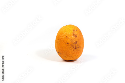 wrinkled orange, stored in the refrigerator, isolated on white background