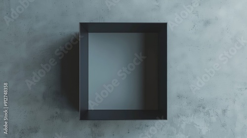 A dark, square shadow box mounted on a textured gray wall, casting subtle shadows.