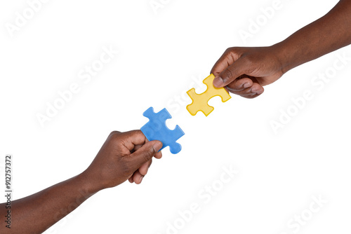 Man trying to match pieces of jigsaw puzzle, isolated on white background