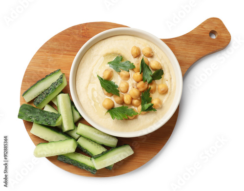 Tasty hummus with chickpeas in bowl and cut cucumbers isolated on white, top view