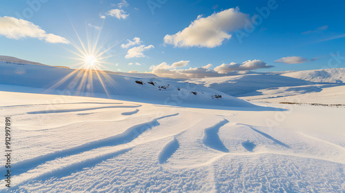 A peaceful snowscape with sun rays piercing through gaps in the winter clouds 