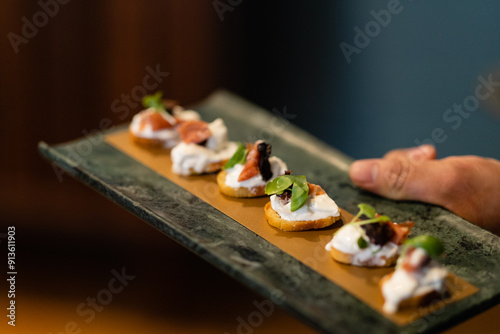 platter of crostini with prosciutto and ricotta