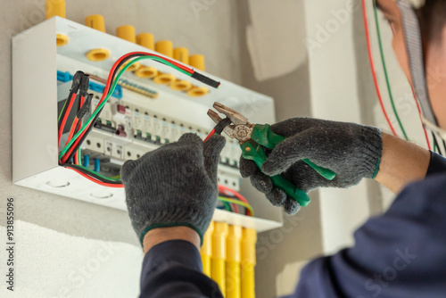 An electrician carefully installs new wiring in a modern home, ensuring safety and efficiency.