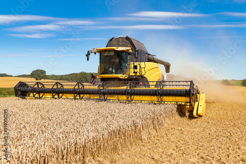 Combine harvester at the grain harvest in the field - 1897