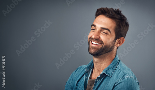 Happy, mockup space and man in studio with positive attitude, confidence and pride. Fashion style, trendy clothes and isolated person with joy, cheerful and excited expression on gray background