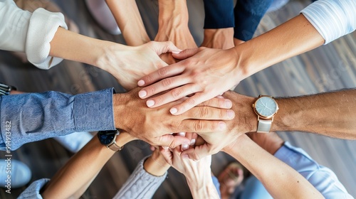 The top-view of diverse people nationalities fold their hands together on each other, symbolizing their unity and support. A team of people who are set up for productive work and a positive result.