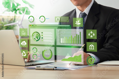 Businessman analyze sustainability investment with icons and Green chart. Concept of ESG, Green businesses, Net zero, Green energy, Carbon neutral, Green technology, and Carbon credit. CSR.